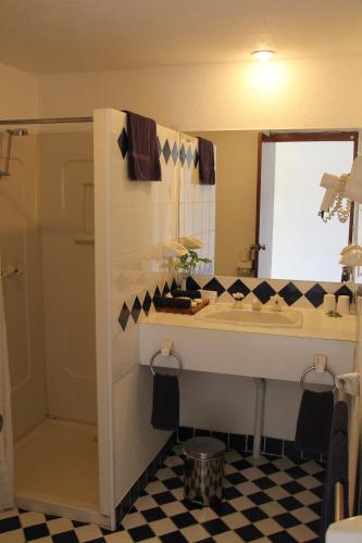 a bathroom with a sink and a mirror at The Melanesian Port Vila in Port Vila