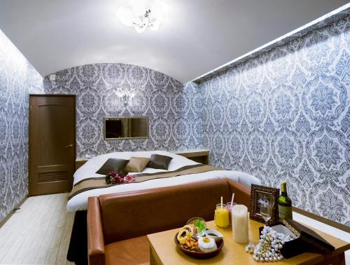a bedroom with a bed with blue wallpaper at Kumamoto Hotel Christmas Forest Garden (Love Hotel) in Shimo-koga