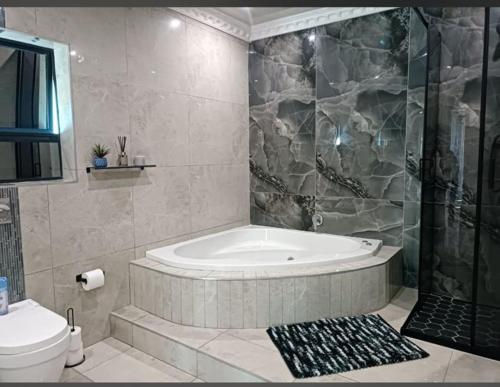 De Rams boutique guest house : حمام مع حوض استحمام ودش ومرحاض