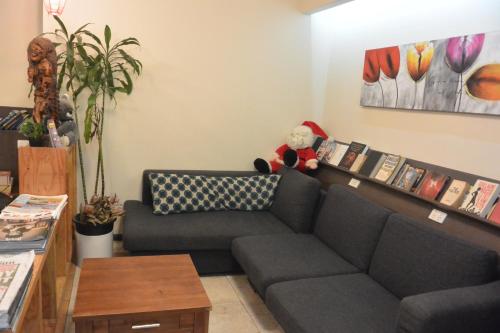 a living room with a couch and a shelf with books at Elizabeth Hostel in Melbourne
