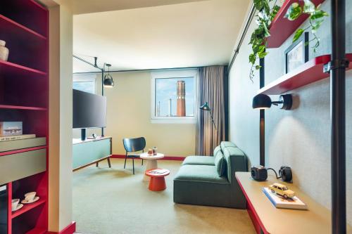 a living room with a couch and a table at Me and All Hotel Berlin East Side, by Hyatt - NEW OPENING in Berlin