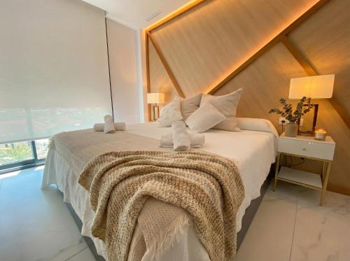a bedroom with a large bed with a large window at holaVivienda - Ático Boutique de Lujo en la Playa in Denia