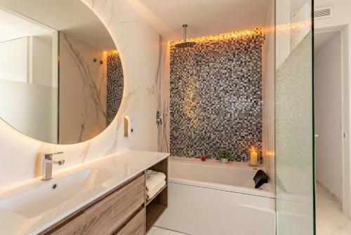 a bathroom with a tub and a sink and a shower at holaVivienda - Ático Boutique de Lujo en la Playa in Denia