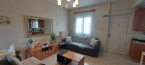 a living room with a couch and a mirror at Aegean Villa in Artemida