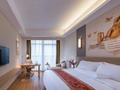 Ένα ή περισσότερα κρεβάτια σε δωμάτιο στο Vienna International Hotel Chengdu New Global Exhibition Center