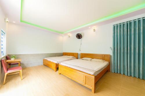 Ένα ή περισσότερα κρεβάτια σε δωμάτιο στο ML Homestay