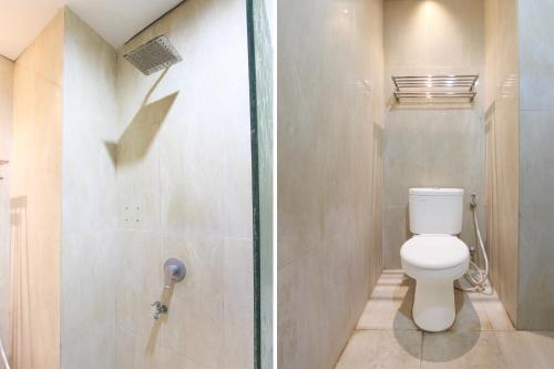 a bathroom with a toilet and a shower at Collection O near Stadion Manahan formerly Graha Laweyan Solo in Bonorejo