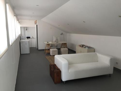 a living room with a white couch and a table at Atouguia Apartment in Funchal