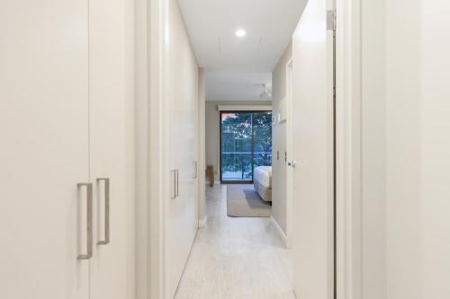 a hallway of a house with white walls at Darwin Waterfront Luxury Suites in Darwin