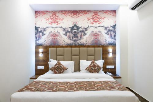 Ένα ή περισσότερα κρεβάτια σε δωμάτιο στο Sitharth Hotel