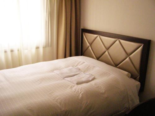 Postel nebo postele na pokoji v ubytování Hotel Terrace Yokohama