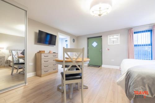 a bedroom with a bed and a table and a mirror at Homestead Hillsborough in Hillsborough