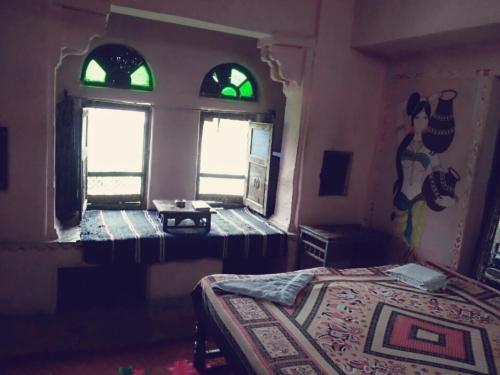 a bedroom with two beds and two windows at Haveli Uma Megh Tourist Guest House in Būndi