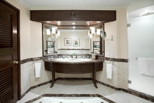 a bathroom with a large sink and a large mirror at Dorsett Grand Labuan in Labuan