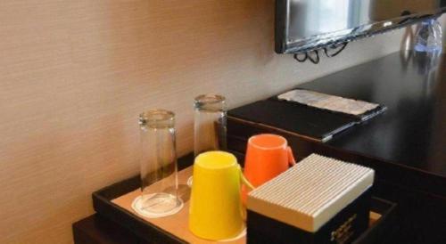 a table with two cups and a book on it at Wyndham Grand Plaza Royale Mingfa Zhangzhou in Zhangzhou