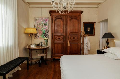 Un dormitorio con una cama, una mesa y una lámpara de araña. en Suite dans une échoppe, en Bègles