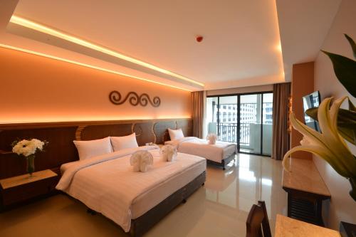 En eller flere senge i et værelse på Le Bali Resort & Spa