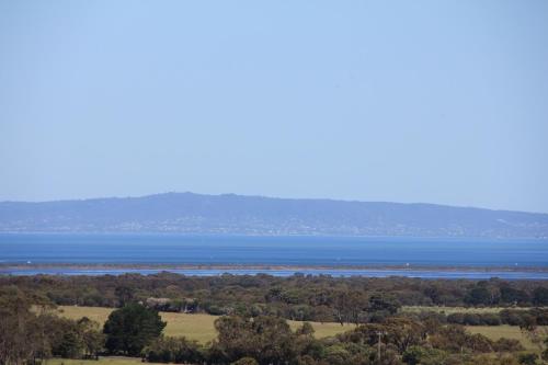 a view of the water from the top of a hill at Bellarine Villas in Drysdale