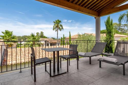 a patio with a table and chairs on a balcony at Villa Cosy, hotel & spa in Saint-Tropez