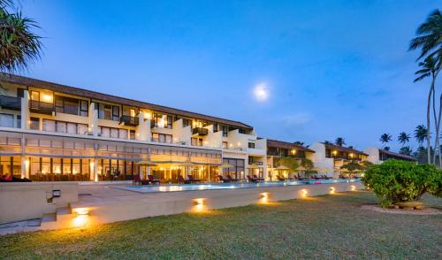 a large building with lights in front of it at Grand Beach in Wadduwa