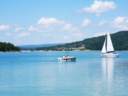 two boats floating on a large body of water at Miejscówka Werlas in Werlas