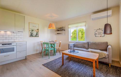 a living room with a couch and a table at Lovely Home In Myggenäs With Sauna in Höviksnäs
