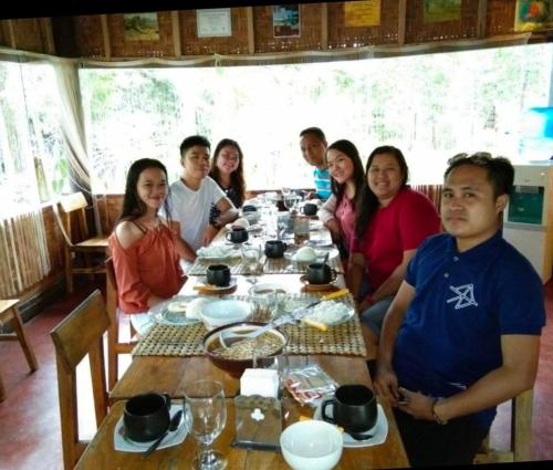 a group of people sitting around a table at Star Lotus Guesthouse in Sampong
