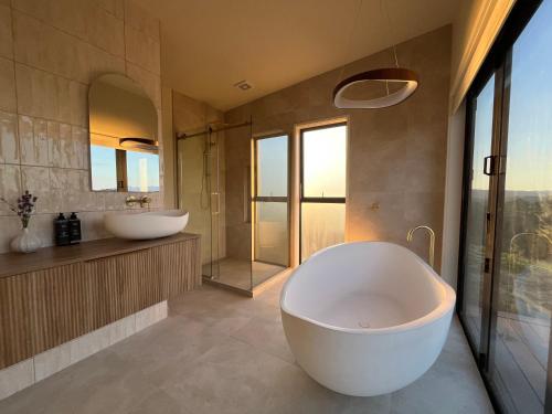 a large bathroom with two sinks and a large tub at Golden Ridge Retreat in Otorohanga