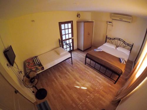 En eller flere senge i et værelse på Palm view inn