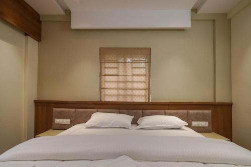a bedroom with a large bed with two pillows at CaaZa Ventura in Sultan Bathery