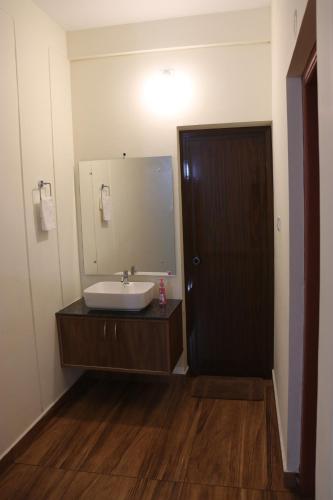 a bathroom with a sink and a mirror at CaaZa Ventura in Sultan Bathery