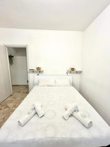 a bedroom with a white bed with two towels on it at Skyscraper 11 in Cinisello Balsamo