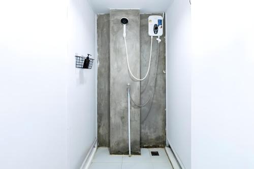 een douchecabine in een badkamer met een slang bij XX Mitr INN Sukhumvit Soi 2 in Bang Kapi