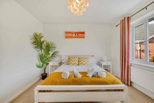 a bedroom with a bed with towels on it at Spacious 4 Bedroom Warrington House with Free Parking Perfect for Contractors, Families and Business Guests in Great Sankey