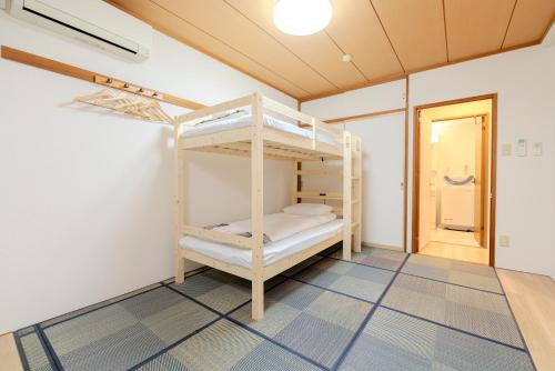 Postel nebo postele na pokoji v ubytování 匯金中葛西ビル