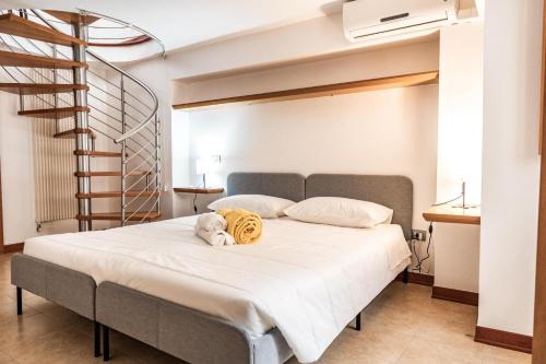 a bed with a stuffed animal on top of it at La finestra sulla piazza in Pisticci