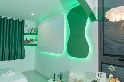a bathroom with a blue light on the wall at Ori Home in Ho Chi Minh City