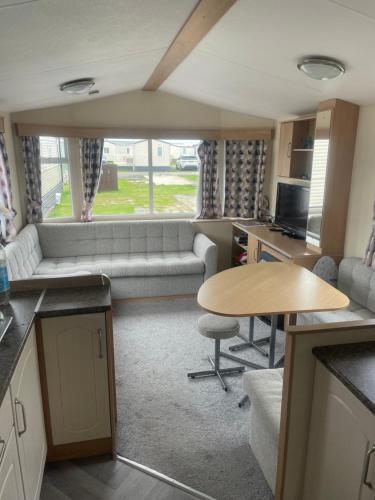 a living room with a couch and a table at Gemini in Heysham