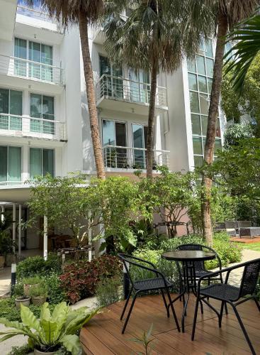 a patio with chairs and a table in front of a building at Townhouse PK Garden in Bangkok