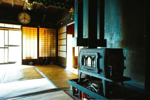 a room with a stove in the middle of a room at Minamikoma-gun - House - Vacation STAY 19040 in Kajikazawa