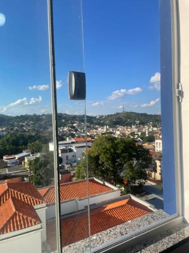 a view of a city from a window at Flat 2 ao lado da UFSJ e Igreja São Francisco in São João del Rei