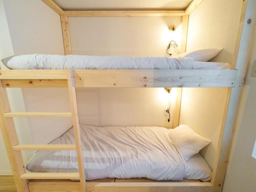 two bunk beds in a small room with a pillow at RetroSpect Stay Yokohama - Vacation STAY 99033v in Yokohama