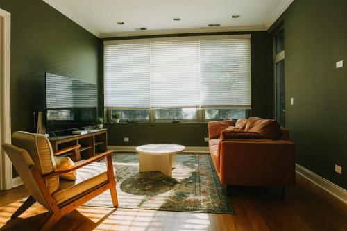 a living room with a couch and a table at Private Balcony 1 Garage Parking Sleeps 6 in Chicago