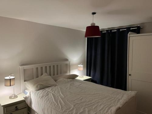 a bedroom with a bed and a black curtain at 3 bed house with stunning views on Achill Island in Sraheens