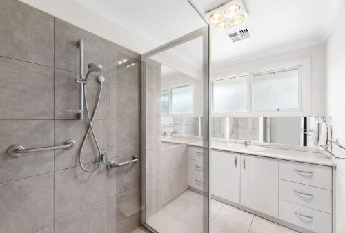 a bathroom with a shower and a sink at Lonny Coastal Escape in Point Lonsdale