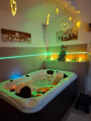 a large bath tub with lights in a bathroom at escapade coeur provence in La Celle