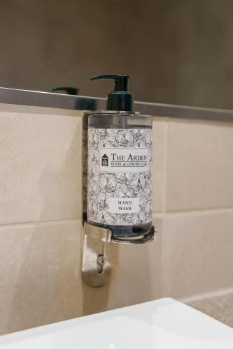 a soap dispenser on the wall of a bathroom at Arden Hotel And Leisure Club in Bickenhill