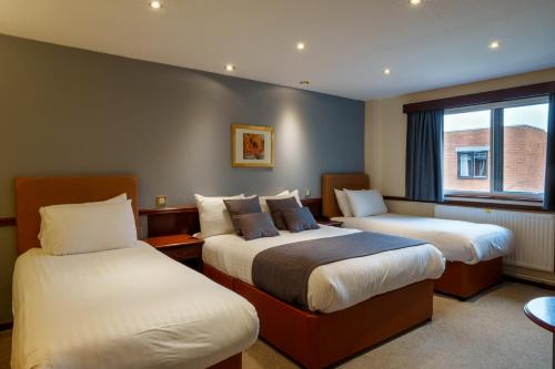 Postel nebo postele na pokoji v ubytování Arden Hotel And Leisure Club