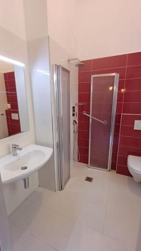 a bathroom with a shower and a sink and a toilet at Hotel Bristol in Laigueglia