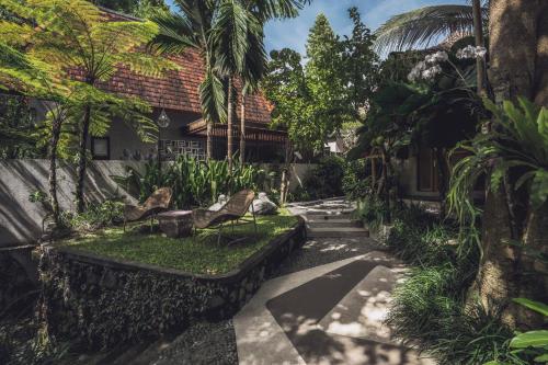 a garden in front of a house at Amarea Resort & Spa Ubud by Ini Vie Hospitality in Ubud